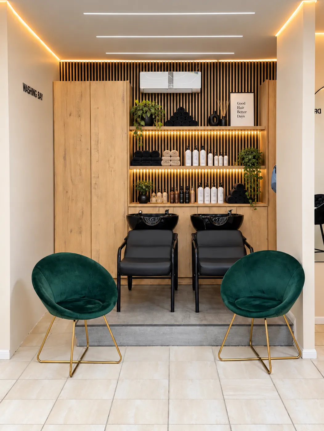 Washing bay with two basins and green velvet chairs